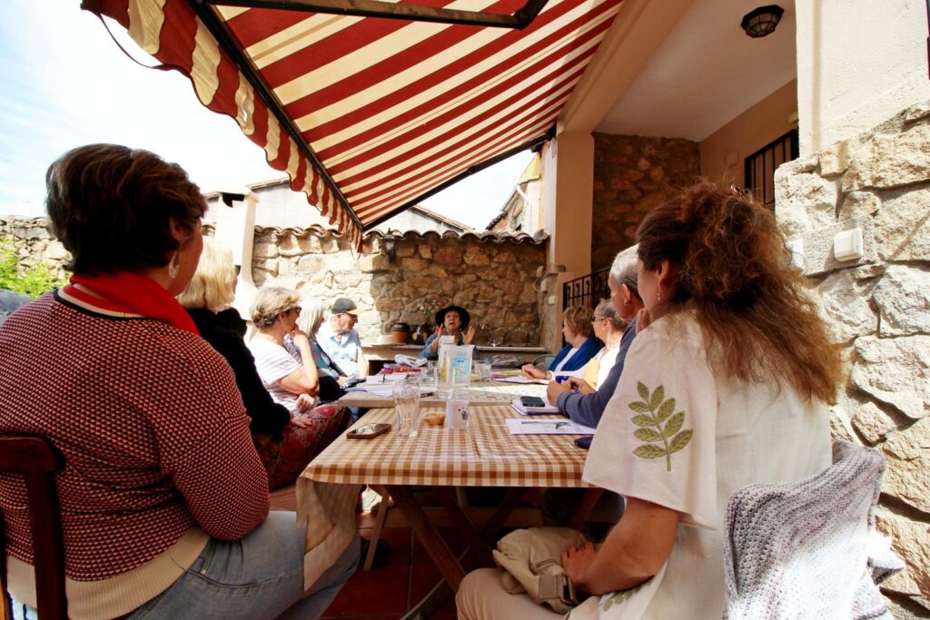 Spanish class at a long table under the striped awning on the terrace