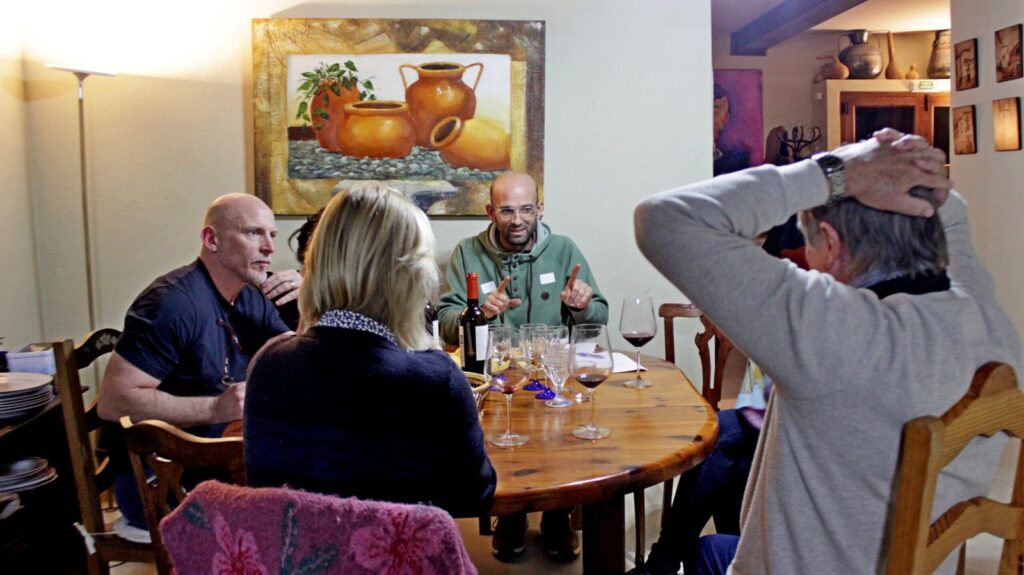 Students chatting at the round table in the dining room
