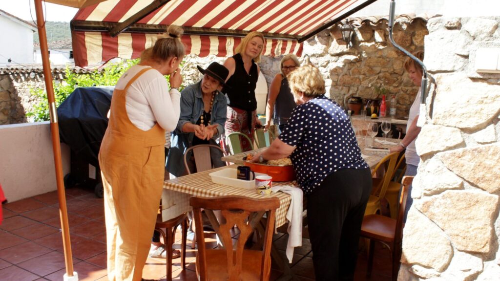 Cooking together under the striped awning on the terrace