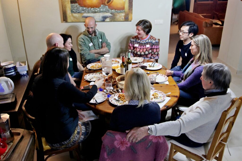 Students and teachers sharing a meal at the round table